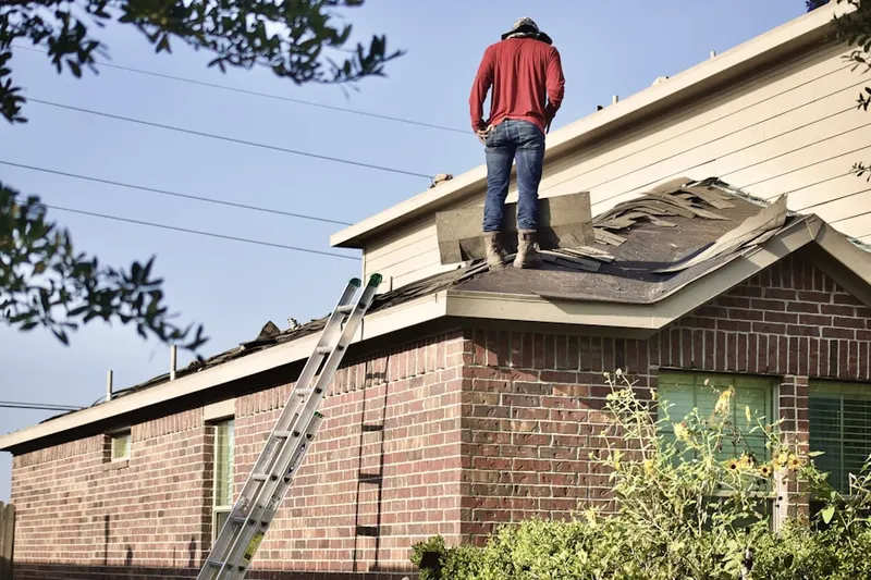 Professional roofer working on a residential roof in Landrum